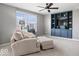 Comfortable living room featuring a cozy chair, ottoman, and built-in shelving unit with a flat screen television at 957 Commander Ct, Westfield, IN 46074
