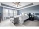 Relaxing main bedroom with natural light, tray ceilings, and a bench at the end of the bed at 957 Commander Ct, Westfield, IN 46074