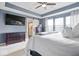 Bedroom with white comforter, bedside tables, dresser, and open bathroom access at 957 Commander Ct, Westfield, IN 46074