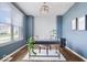 Bright office with neutral walls, modern chandelier, and large window at 957 Commander Ct, Westfield, IN 46074