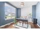 Bright office with neutral walls, modern chandelier, and large window overlooking backyard at 957 Commander Ct, Westfield, IN 46074