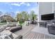 Outdoor living area with a grill, outdoor TV, and comfortable seating area at 957 Commander Ct, Westfield, IN 46074