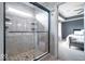 Tiled shower with a seamless glass door, multiple shower heads, and built in shelving at 957 Commander Ct, Westfield, IN 46074