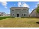View of the back of the house showcasing large backyard and patio with sliding glass door at 10138 Redwood Peak Ln, Indianapolis, IN 46259