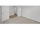 Bright bedroom with neutral carpet, white walls, and a glimpse into the hallway with wood-look flooring at 10138 Redwood Peak Ln, Indianapolis, IN 46259