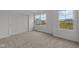 Bright bedroom featuring plush carpeting, a closet, and natural light from two windows at 10138 Redwood Peak Ln, Indianapolis, IN 46259
