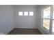 Clean, carpeted bedroom featuring three large windows, bright natural light, and neutral walls at 10138 Redwood Peak Ln, Indianapolis, IN 46259
