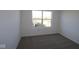 Clean, carpeted bedroom featuring one large window, bright natural light, and neutral walls at 10138 Redwood Peak Ln, Indianapolis, IN 46259