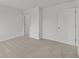 A bright bedroom shows a closet and an open doorway with neutral carpet at 10138 Redwood Peak Ln, Indianapolis, IN 46259