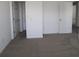 Bedroom with carpet, a window, and doors to other rooms at 10138 Redwood Peak Ln, Indianapolis, IN 46259