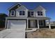 Two-story home with a white two-car garage, covered porch, gray siding and manicured lawn at 10138 Redwood Peak Ln, Indianapolis, IN 46259