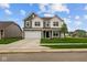 Charming two-story home featuring a well-manicured lawn and a two-car garage on a sunny day at 10138 Redwood Peak Ln, Indianapolis, IN 46259