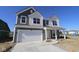 Two-story home with a white two-car garage, covered porch, gray siding and manicured lawn at 10138 Redwood Peak Ln, Indianapolis, IN 46259
