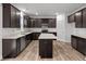 Modern kitchen with stainless steel appliances, dark wood cabinetry, and a central island at 10138 Redwood Peak Ln, Indianapolis, IN 46259