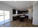 Modern kitchen features dark wood cabinetry, island, stainless steel appliances, and hardwood floors at 10138 Redwood Peak Ln, Indianapolis, IN 46259