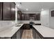Well-lit kitchen featuring stainless steel appliances, granite countertops, and dark wood cabinetry at 10138 Redwood Peak Ln, Indianapolis, IN 46259