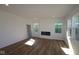 Bright, open living room with hardwood floors, fireplace, and large windows offering ample natural light at 10138 Redwood Peak Ln, Indianapolis, IN 46259