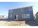 New construction home showing the backyard exterior with blue siding and windows at 10138 Redwood Peak Ln, Indianapolis, IN 46259