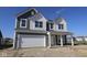 Charming two-story home featuring gray siding, a two-car garage, and a welcoming front porch at 10138 Redwood Peak Ln, Indianapolis, IN 46259