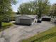 Aerial view of a ranch-style house, an attached garage, a detached garage, and a spacious paved driveway at 1029 Price Rd, Avon, IN 46123
