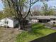 Spacious backyard featuring green grass, storage buildings, and a greenhouse, perfect for outdoor living at 1029 Price Rd, Avon, IN 46123