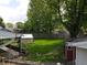 Backyard aerial showcases fenced yard, greenhouse, and shady area at 1029 Price Rd, Avon, IN 46123