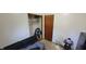 Bright bedroom featuring a closet, wooden door, and small desk at 1029 Price Rd, Avon, IN 46123