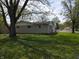 Brick ranch-style house with well-manicured lawn and mature trees, offering a serene setting at 1029 Price Rd, Avon, IN 46123