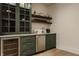 Contemporary bar area featuring stainless steel appliances, custom cabinets, and floating wooden shelves at 10415 Westfield Blvd, Carmel, IN 46280
