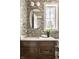 Charming bathroom with leafy wallpaper, dark wood vanity, and oval mirror at 10415 Westfield Blvd, Carmel, IN 46280
