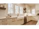 Bright kitchen with white cabinets, stainless steel appliances, white countertops, and a farmhouse sink at 10415 Westfield Blvd, Carmel, IN 46280