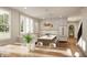 Bright kitchen featuring white cabinetry, wood flooring, an island with seating, and stainless steel appliances at 10415 Westfield Blvd, Carmel, IN 46280