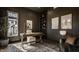 Sophisticated home office with ample natural light, dark walls, and built in shelving at 10415 Westfield Blvd, Carmel, IN 46280