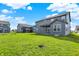 Expansive backyard with well-manicured lawn and neighboring homes, creating a peaceful and Gathering-friendly environment at 10423 Hamburg Dr, Fortville, IN 46040