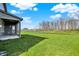Lush backyard featuring green grass and a tranquil pond, creating a serene and inviting outdoor space at 10423 Hamburg Dr, Fortville, IN 46040