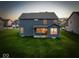 Spacious backyard featuring a covered patio, ideal for relaxing or entertaining at 10423 Hamburg Dr, Fortville, IN 46040