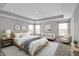 This bedroom features a sitting area, a comfortable bed, and natural light at 10423 Hamburg Dr, Fortville, IN 46040