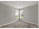 Empty bedroom with carpet, two windows, and neutral walls offering a blank canvas for personalization at 10423 Hamburg Dr, Fortville, IN 46040