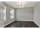 Bright dining room featuring a modern chandelier, gray walls, and stylish flooring at 10423 Hamburg Dr, Fortville, IN 46040
