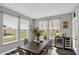 Bright dining room with a view of the backyard, large window, with modern decorations at 10423 Hamburg Dr, Fortville, IN 46040