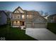 Charming two-story home with three-car garage and well-manicured lawn at 10423 Hamburg Dr, Fortville, IN 46040