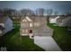 Stunning two-story home with a three-car garage and landscaped front yard at 10423 Hamburg Dr, Fortville, IN 46040