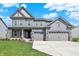 Charming two-story home boasts a three-car garage and a meticulously manicured lawn at 10423 Hamburg Dr, Fortville, IN 46040