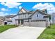 Two-story home with a three-car garage and large driveway at 10423 Hamburg Dr, Fortville, IN 46040