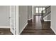 Hallway featuring wood floors, a staircase, and an open floor plan at 10423 Hamburg Dr, Fortville, IN 46040