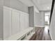 Hallway showcasing a storage bench with coat hooks and an open view into other rooms at 10423 Hamburg Dr, Fortville, IN 46040