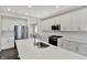 Bright kitchen with stainless steel appliances, subway tile backsplash, large island with hardwood flooring at 10423 Hamburg Dr, Fortville, IN 46040