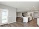 Open concept kitchen with stainless steel appliances, an island, and hardwood floors overlooking the staircase at 10423 Hamburg Dr, Fortville, IN 46040