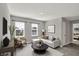 Comfortable living room with neutral decor and large windows, showcasing the home's inviting atmosphere at 10423 Hamburg Dr, Fortville, IN 46040