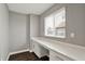 Bright office space featuring a built-in desk, cabinets, and a window overlooking the property at 10423 Hamburg Dr, Fortville, IN 46040
